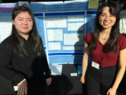 Students standing beside their posterboard