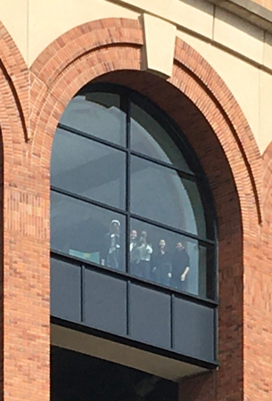 Students waving from a high window