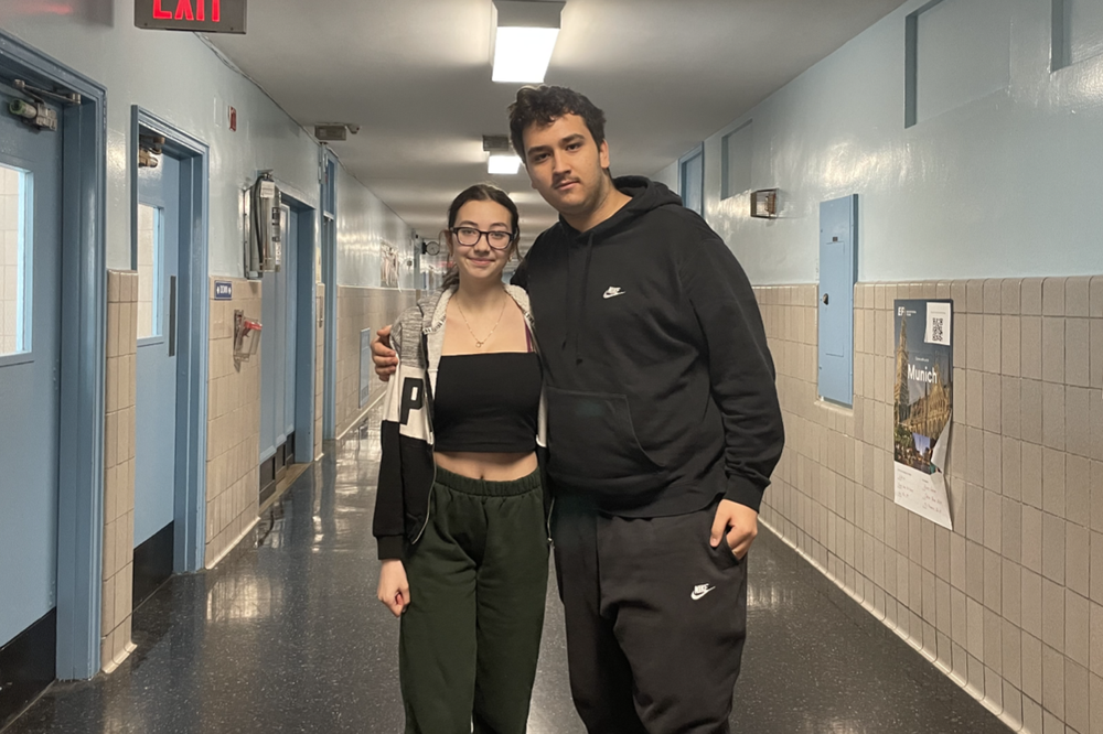 Two students standing in the hallway